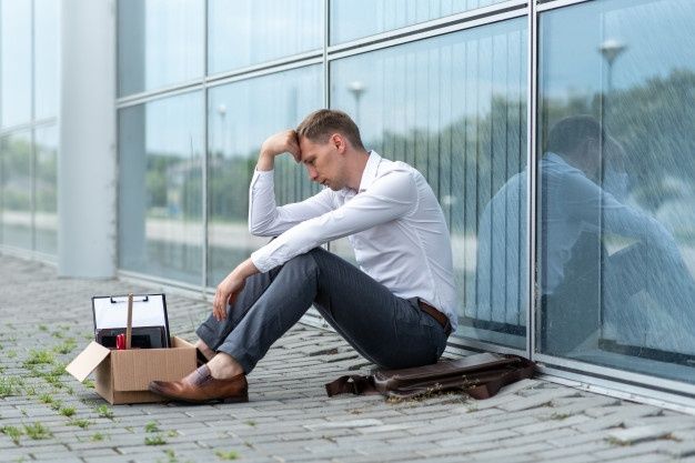 A worker outside the workplace sad